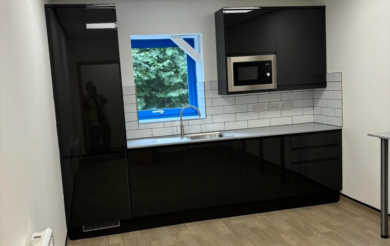 Industrial Urban kitchen with matt black fittings and concrete surfaces